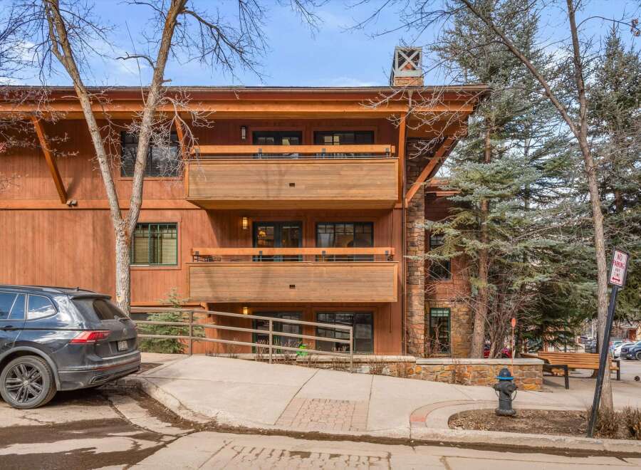 Experience mountain living in this stunning property featuring a warm, wood-clad exterior and multiple balconies perfect for enjoying the crisp alpine air.