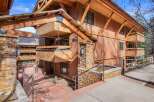 Experience mountain living in this stunning timber-framed residence, featuring natural stone accents and expansive wooden balconies perfect for enjoying the crisp alpine air.