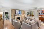 Experience luxury living in this stunning living room, featuring a magnificent stone fireplace as the centerpiece.