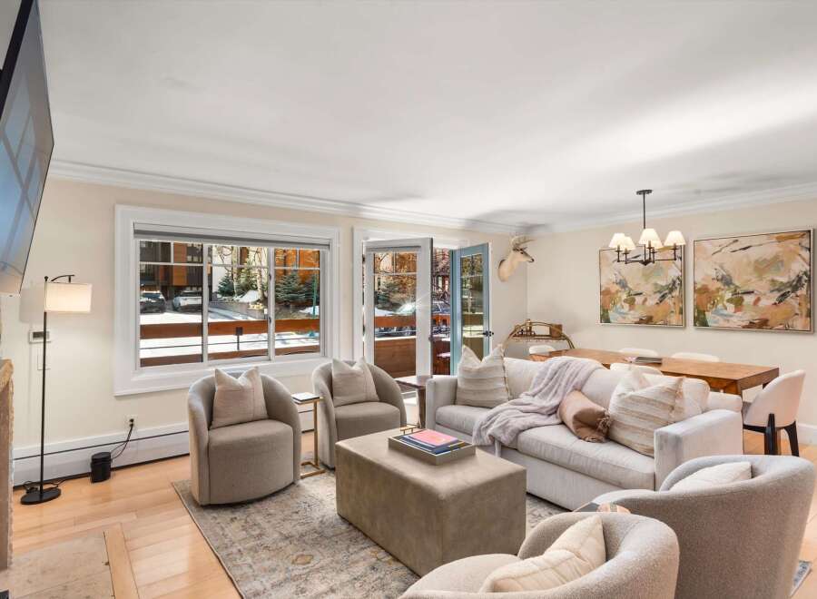 Experience cozy living in this inviting living room, featuring a plush sofa adorned with decorative pillows and a soft throw, perfect for relaxing evenings.