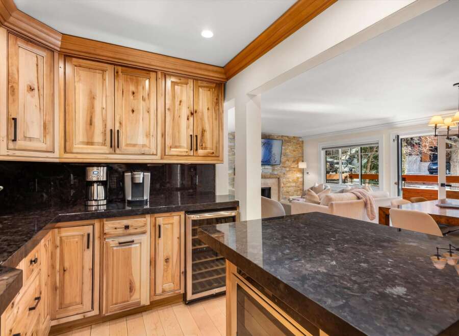 Experience luxury living in this stunning kitchen featuring custom light wood cabinetry and sleek granite countertops.