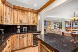 Experience luxury living in this stunning kitchen featuring custom light wood cabinetry and sleek granite countertops.
