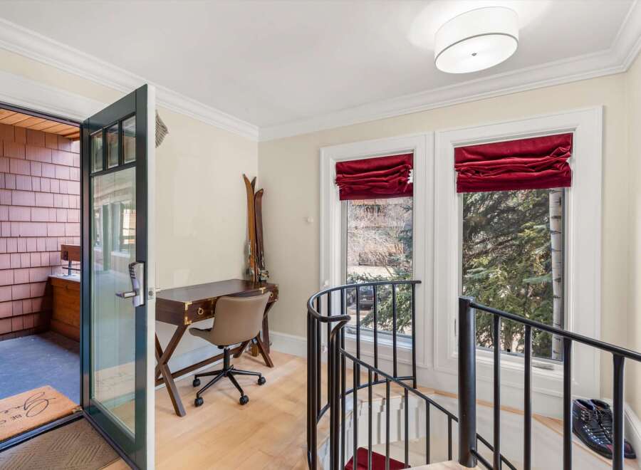 Step into this charming entryway featuring a convenient desk area perfect for managing your affairs.