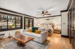 Experience rustic luxury in this spacious bedroom featuring a comfortable king-sized bed adorned with plush pillows and a cozy green throw.