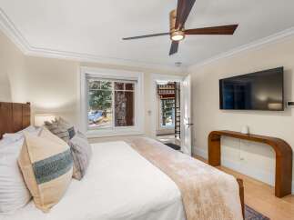 Experience ultimate comfort in this beautifully appointed bedroom, featuring a luxurious leather headboard and plush bedding.
