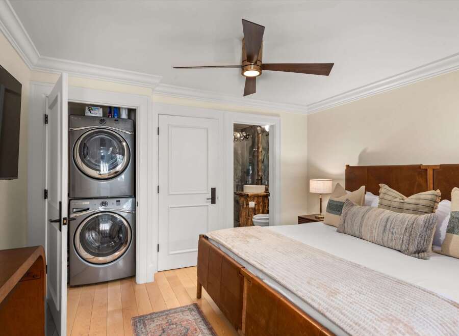 Experience ultimate convenience with a stacked washer and dryer unit discreetly tucked away in a closet.