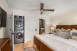 Experience ultimate convenience with a stacked washer and dryer unit discreetly tucked away in a closet.
