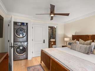 Experience ultimate convenience with a stacked washer and dryer unit discreetly tucked away in a closet.