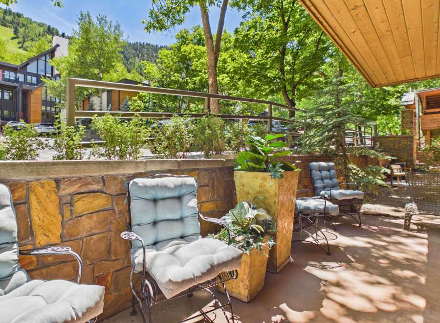Enjoy the serene mountain views from this charming outdoor seating area, perfect for relaxing or entertaining.