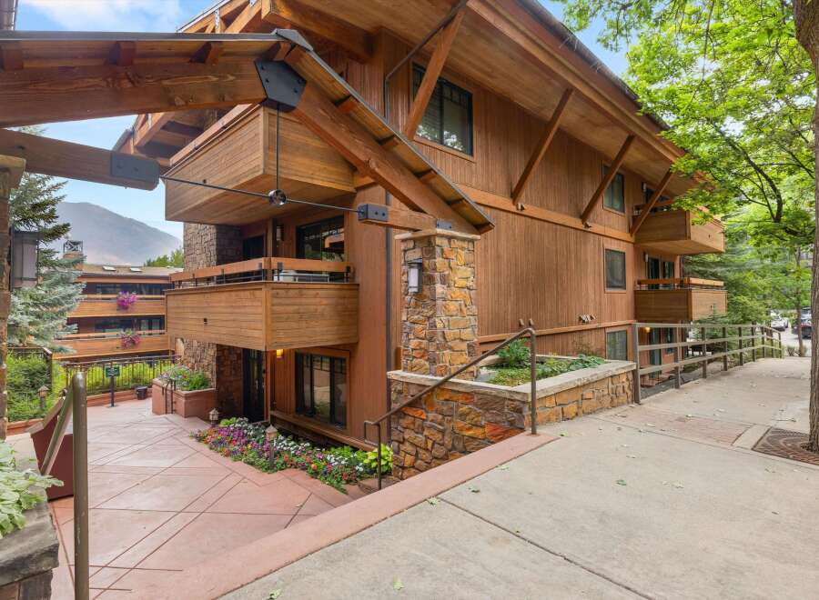 Experience mountain living in this stunning timber-framed residence, featuring natural wood siding and stone accents.