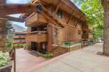 Experience mountain living in this stunning timber-framed residence, featuring natural wood siding and stone accents.