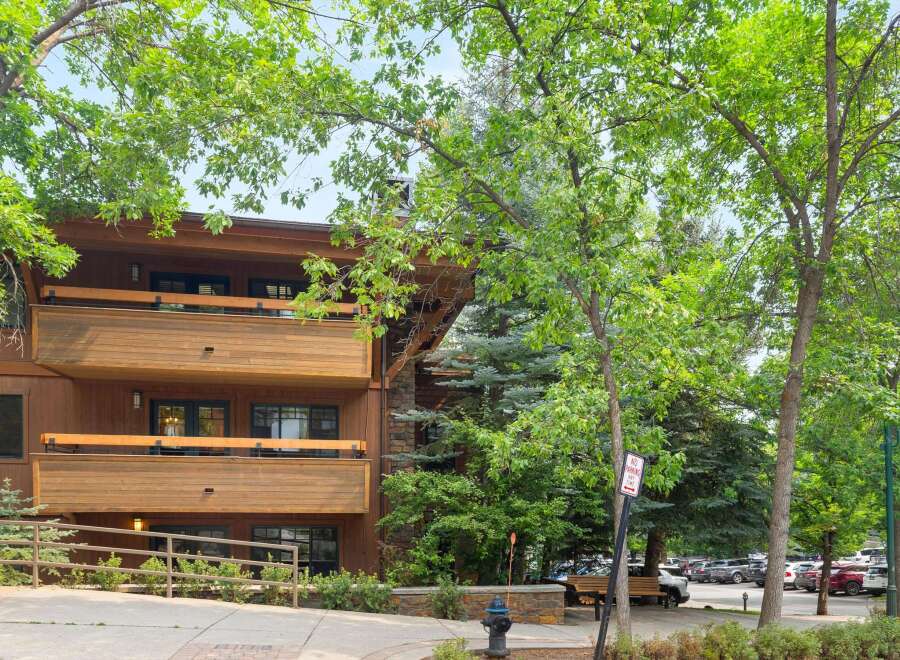 Experience mountain living in this charming property featuring a beautiful wooden exterior and multiple balconies perfect for enjoying the fresh air.