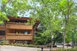 Experience mountain living in this charming property featuring a beautiful wooden exterior and multiple balconies perfect for enjoying the fresh air.