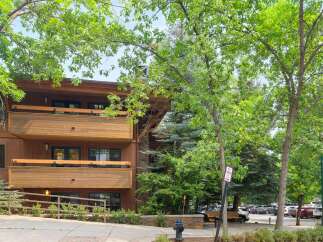 Experience mountain living in this charming property featuring a beautiful wooden exterior and multiple balconies perfect for enjoying the fresh air.