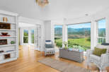 Experience breathtaking mountain views from this stunning living area, featuring expansive windows that flood the space with natural light.