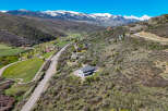 Nestled in a picturesque mountain valley, this stunning property offers breathtaking panoramic views of snow-capped peaks.