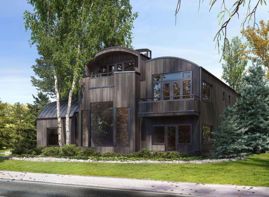Experience modern architectural brilliance with this stunning home, featuring a unique curved roofline and dark wood siding that blends seamlessly with the natural surroundings.