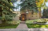 Charming home with a welcoming entryway featuring a bright yellow door and a festive wreath.
