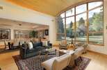 Experience luxurious living in this stunning home featuring a spacious living area with a plush sectional sofa and a glass coffee table, perfect for entertaining.