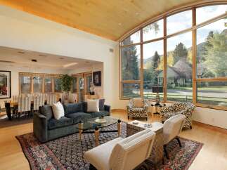 Experience luxurious living in this stunning home featuring a spacious living area with a plush sectional sofa and a glass coffee table, perfect for entertaining.