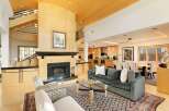 Experience luxury living in this stunning open-concept home, featuring a grand fireplace as the centerpiece of the living area.