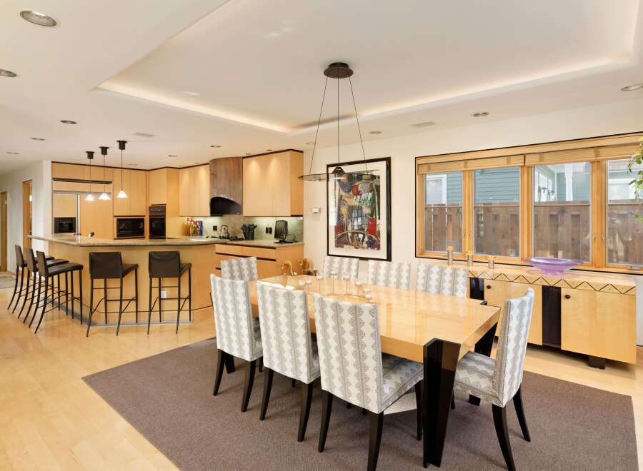 This spacious open-concept kitchen and dining area features a large island with bar seating, perfect for casual meals or entertaining.