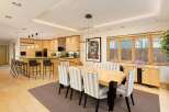 This spacious open-concept kitchen and dining area features a large island with bar seating, perfect for casual meals or entertaining.