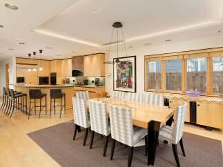 This spacious open-concept kitchen and dining area features a large island with bar seating, perfect for casual meals or entertaining.