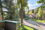 Experience the charm of autumn in this picturesque neighborhood, featuring beautiful homes nestled amongst vibrant fall foliage and mature trees.