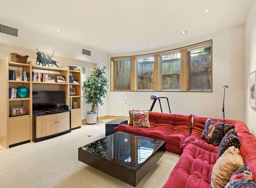 This inviting living room features a plush red sectional sofa, perfect for relaxing or entertaining.