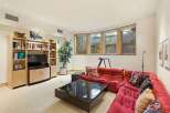 This inviting living room features a plush red sectional sofa, perfect for relaxing or entertaining.