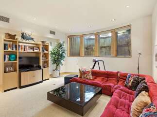 This inviting living room features a plush red sectional sofa, perfect for relaxing or entertaining.