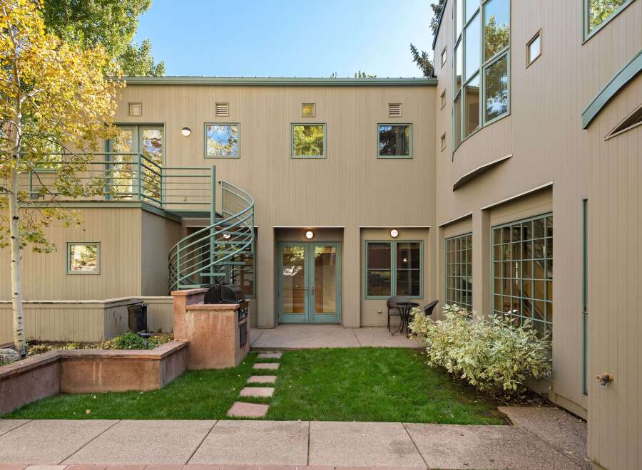This charming property features a private backyard oasis perfect for entertaining, complete with a built-in grill and ample seating areas.