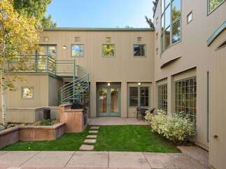 This charming property features a private backyard oasis perfect for entertaining, complete with a built-in grill and ample seating areas.