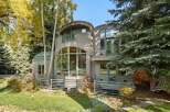 Experience modern living in this unique home featuring striking architectural curves and expansive windows that invite natural light.