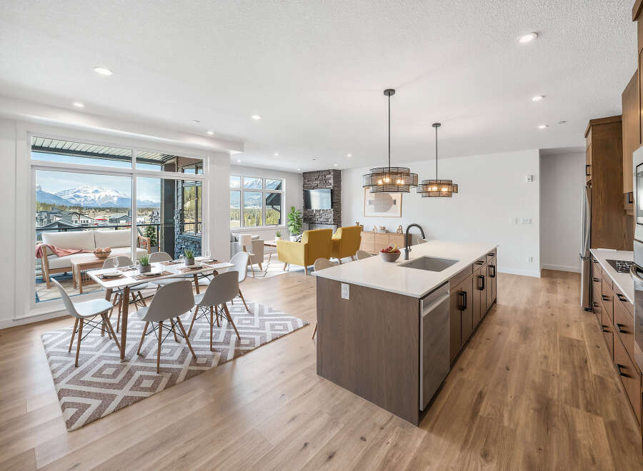 Experience modern living in this stunning open-concept space, featuring a gourmet kitchen with a large island and sleek cabinetry.