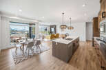 Experience modern living in this stunning open-concept space, featuring a gourmet kitchen with a large island and sleek cabinetry.