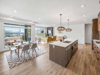 Experience modern living in this stunning open-concept space, featuring a gourmet kitchen with a large island and sleek cabinetry.
