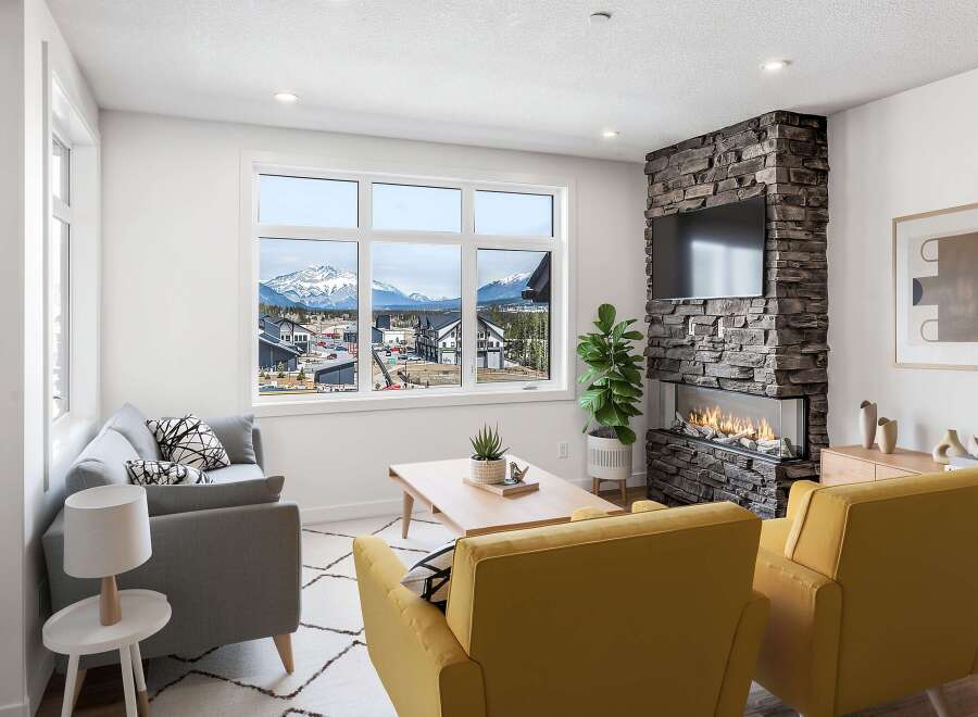 Experience modern living with this stunning living room featuring a sleek stone fireplace and a large window offering breathtaking mountain views.