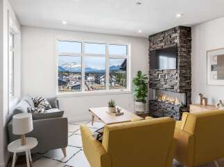 Experience modern living with this stunning living room featuring a sleek stone fireplace and a large window offering breathtaking mountain views.