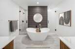 Experience ultimate relaxation in this luxurious bathroom, featuring a stunning freestanding bathtub perfect for unwinding.