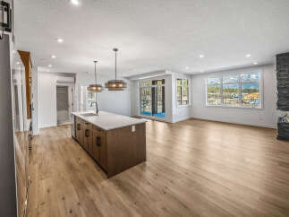 Experience modern living in this stunning open-concept home featuring a spacious kitchen island perfect for entertaining.