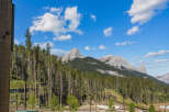 Experience breathtaking mountain views from this stunning property, nestled amidst a lush forest.