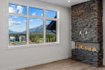 Experience breathtaking mountain views from this stunning property, framed perfectly by a large, multi-pane window.