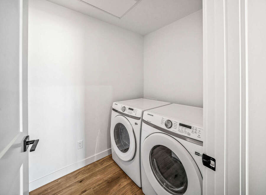 Discover the convenience of this dedicated laundry space, featuring a stacked Samsung washer and dryer set.