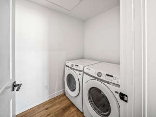 Discover the convenience of this dedicated laundry space, featuring a stacked Samsung washer and dryer set.