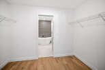 Step into this spacious walk-in closet, featuring ample shelving for all your storage needs.