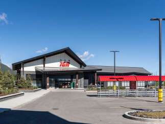 Discover this modern IGA grocery store, featuring a striking architectural design with a prominent IGA logo.