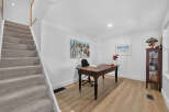 Discover a functional home office space featuring a classic wooden desk and chair, perfect for productivity.