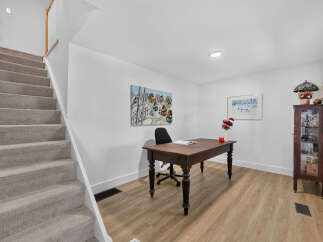 Discover a functional home office space featuring a classic wooden desk and chair, perfect for productivity.